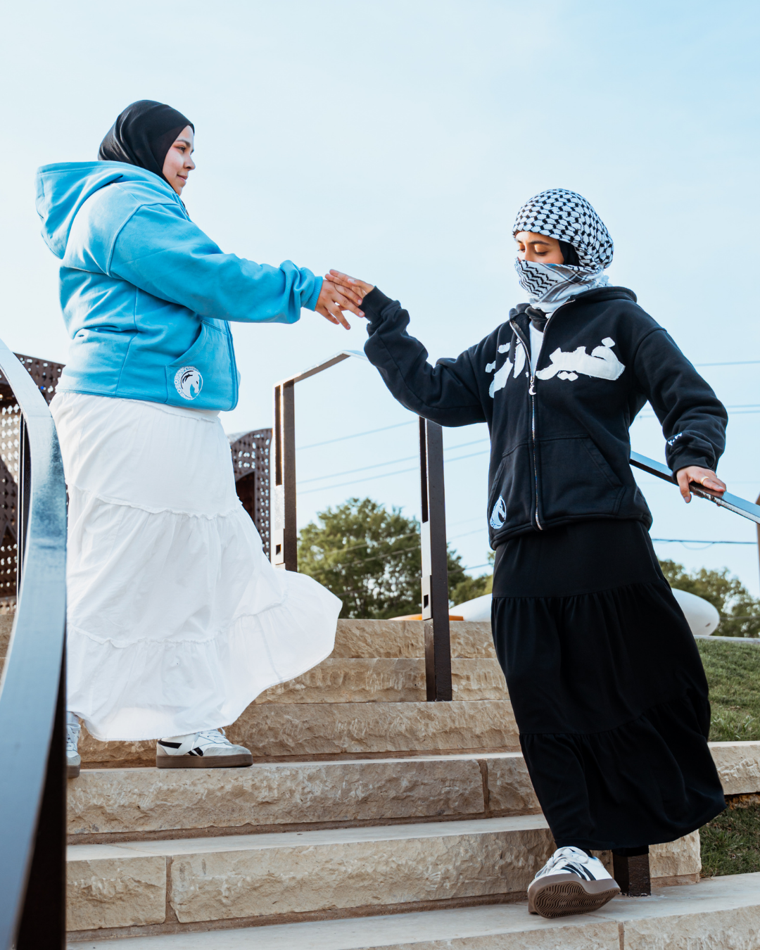 Models wearing the blue and black MSA hoodies outdoors.