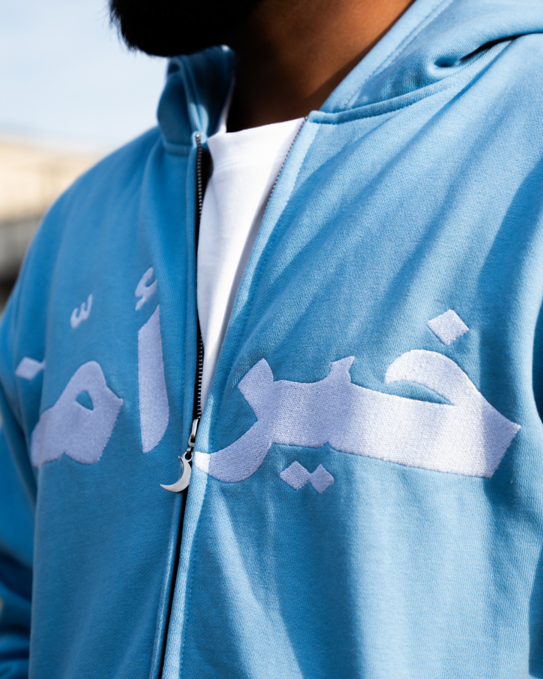Close-up detail of the powder blue MSA hoodie embroidery.