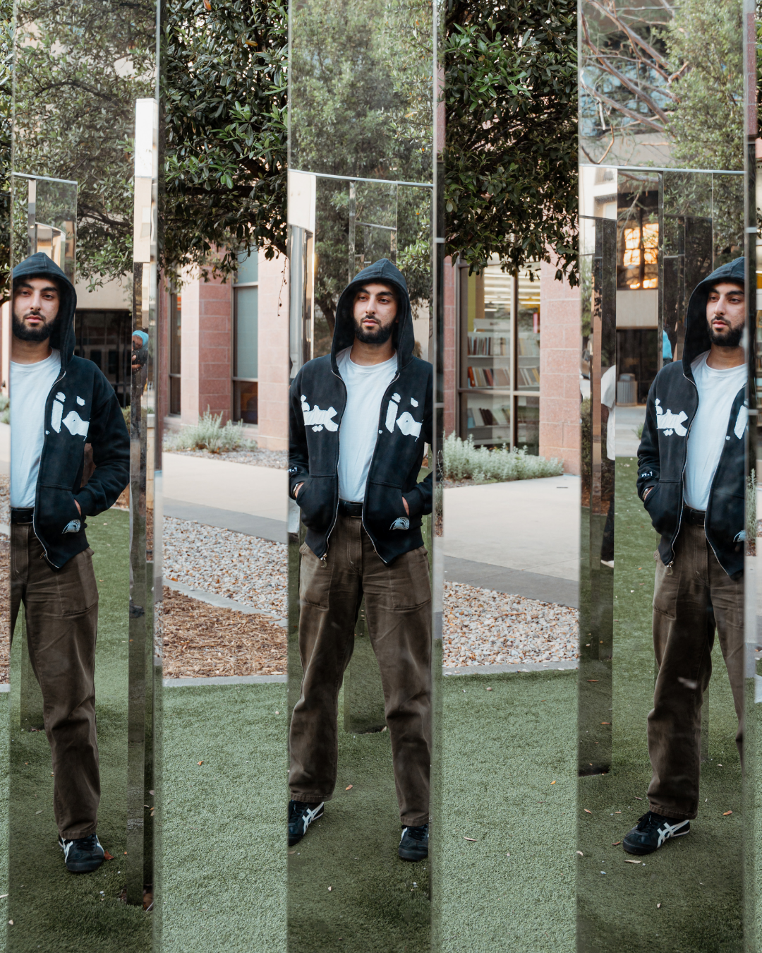 Black hoodie reflected across mirrored panels.